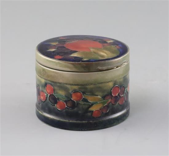 A Moorcroft pomegranate pattern drum shaped box and cover, c.1918-26, diameter 8.8cm